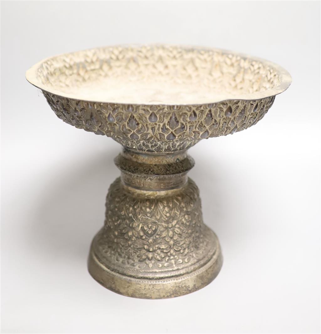 A late 19th/early 20th century Burmese? repousse white metal pedestal bowl(a.f.), height 24cm, gross 29.5oz.